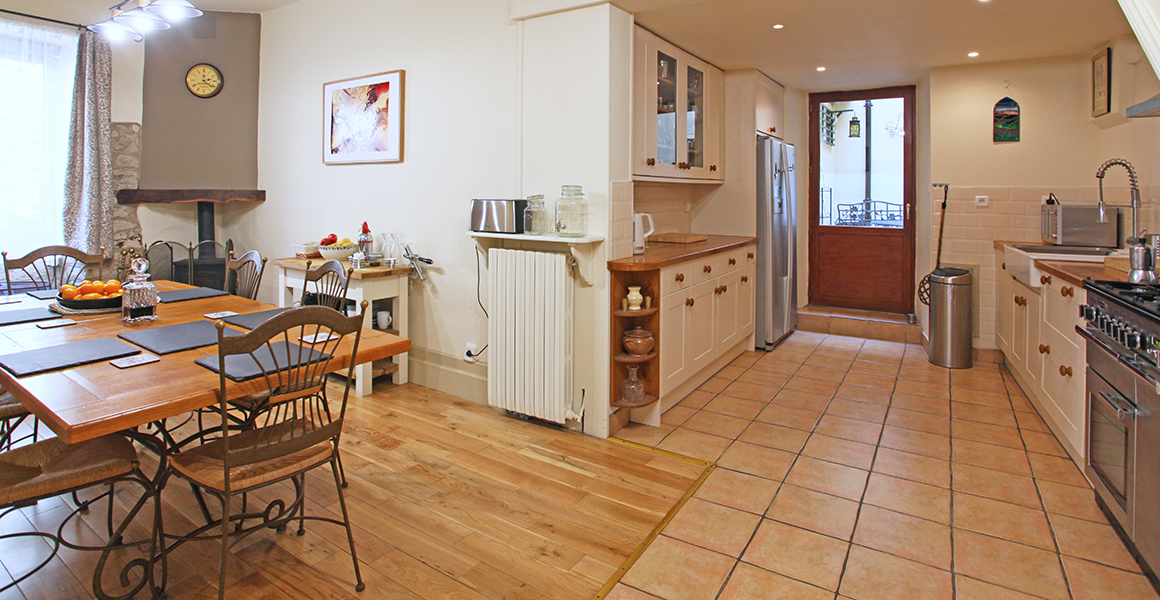 Large kitchen dining room with door to small courtyard terrace